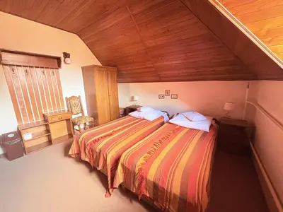 a bedroom with a large bed in a room at Pensjonat Rezydencja Zuzanna Bed&Breakfast Sucha Beskidzka in Sucha Beskidzka
