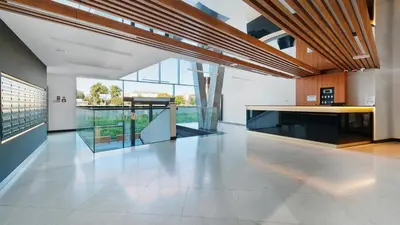 a large room with a white floor and glass walls at Riva Verona, Sun & Snow in Kraków