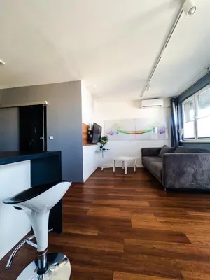 a living room with a couch and a table at Romanowicza Street - Zabłocie - parking free in Kraków