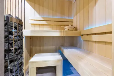 a sauna with wooden shelves and a bench in it at Ucieknij do luksusu Villa Wola2 in Kraków
