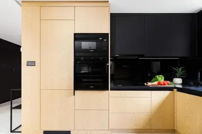a kitchen with black appliances and black cabinets at Ucieknij do luksusu Villa Wola2 in Kraków