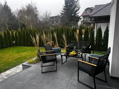 a patio with chairs and a table and a couch at Ucieknij do luksusu Villa Wola2 in Kraków
