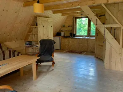 a room with a table and a chair in a cabin at Pszczela Oaza in Bulowice