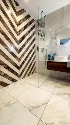 a bathroom with a glass shower and a sink at Royal Blue Place Cracow in Kraków