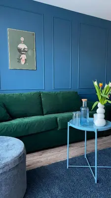 a living room with a green couch and a table at Royal Blue Place Cracow in Kraków