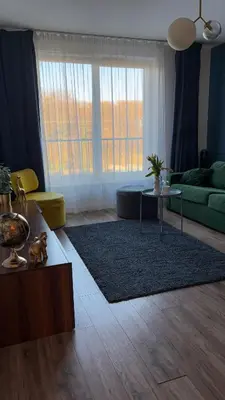 a living room with a couch and a table at Royal Blue Place Cracow in Kraków