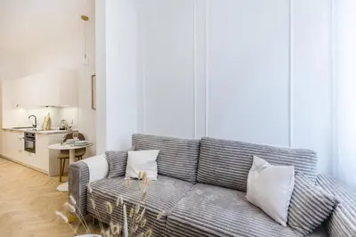 a living room with a couch and a kitchen at Apartament Długa 24 in Kraków