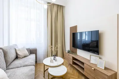 a living room with a couch and a flat screen tv at Apartament Długa 24 in Kraków