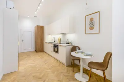 a kitchen with a table and chairs in a room at Apartament Długa 24 in Kraków