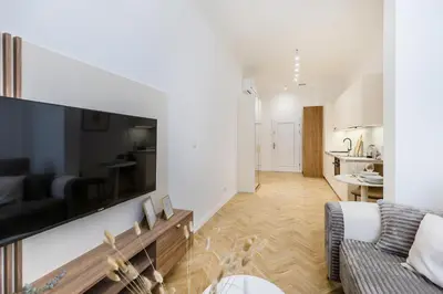 a living room with a couch and a tv at Apartament Długa 24 in Kraków