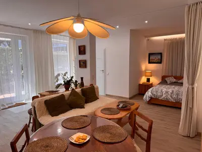 a living room with a couch and a bed at Mieszkanie bez barier, przytulność na każdym kroku in Myślenice