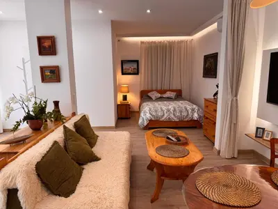 a living room with a couch and a bed at Mieszkanie bez barier, przytulność na każdym kroku in Myślenice