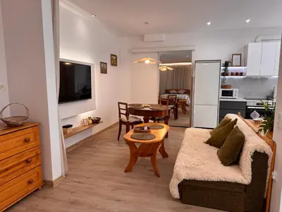 a living room with a couch and a table at Mieszkanie bez barier, przytulność na każdym kroku in Myślenice
