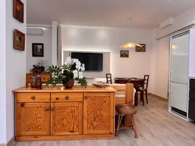a living room with a kitchen and a dining room at Mieszkanie bez barier, przytulność na każdym kroku in Myślenice
