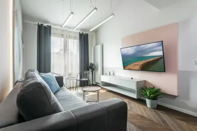 a living room with a couch and a table at Kossak Residence - by Wawel Castle in Kraków