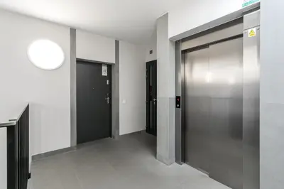 a hallway with elevator doors in a building at Kossak Residence - by Wawel Castle in Kraków