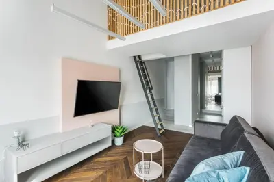 a living room with a couch and a flat screen tv at Kossak Residence - by Wawel Castle in Kraków