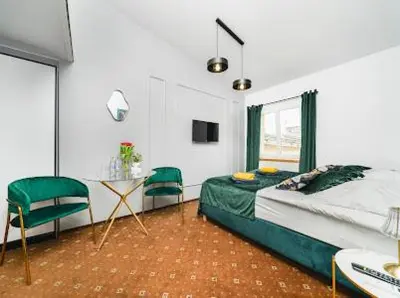 a bedroom with a bed and a table and chairs at Queen Bee Apartments Krakow Old Town in Kraków