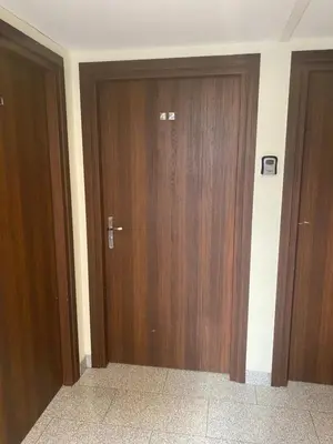 two wooden doors in a room with at Queen Bee Apartments Krakow Old Town in Kraków