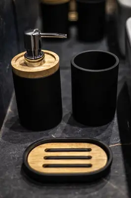 a black and wooden comb and a cup on a counter at Exclusive place with underground parking and terrace in Oświęcim