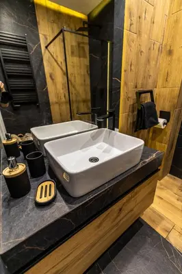 a bathroom with a white sink on a counter at Exclusive place with underground parking and terrace in Oświęcim