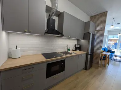 a kitchen with a sink and a refrigerator at Magic Apartments - Zibi in Zator