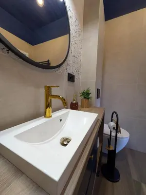 a bathroom with a sink and a mirror at Magic Apartments - Zibi in Zator