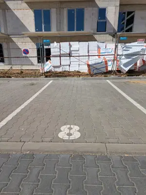 a parking lot with a symbol on the street at Magic Apartments - Zibi in Zator