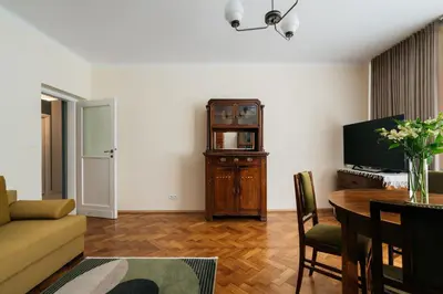 a living room with a couch and a table and a television at Native Apartments Fałata 12 in Kraków