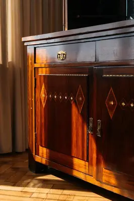 a wooden cabinet with a tv on top of it at Native Apartments Fałata 12 in Kraków