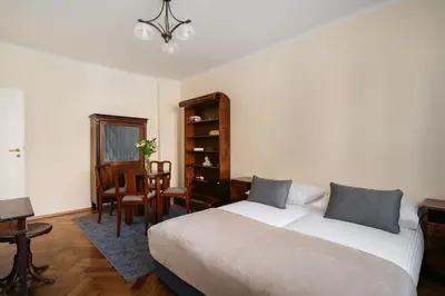 a bedroom with a bed and a table and chairs at Native Apartments Fałata 12 in Kraków