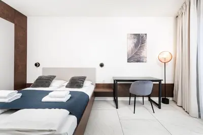 a bedroom with two beds and a desk at City of the Kings-Copper Nest in Kraków