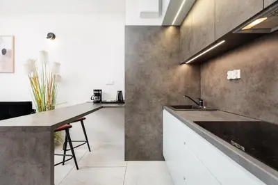 a kitchen with a sink and a counter at City of the Kings-Copper Nest in Kraków