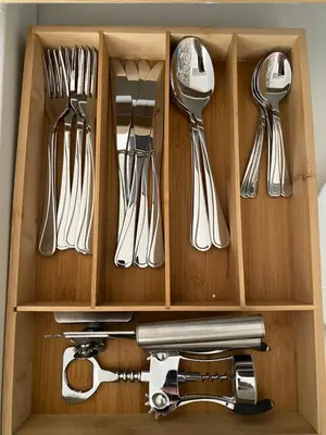 a drawer full of utensils in a wooden box at Queen Bee Apartments Cracow Old Town in Kraków