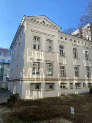 a white building with a lot of windows at Queen Bee Apartments Cracow Old Town in Kraków