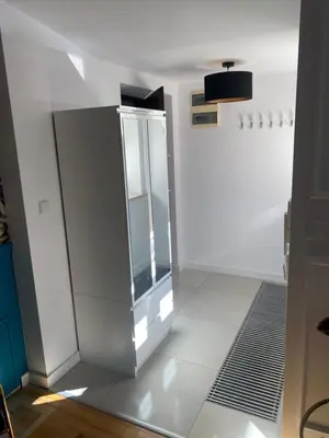 a bathroom with a mirror on a white wall at Queen Bee Apartments Cracow Old Town in Kraków