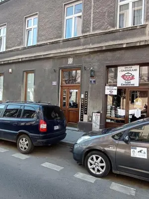 two cars parked in front of a building at Scandi-Style Escape in Krakow in Kraków