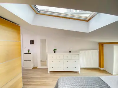 a bedroom with a skylight in the ceiling at Scandi-Style Escape in Krakow in Kraków