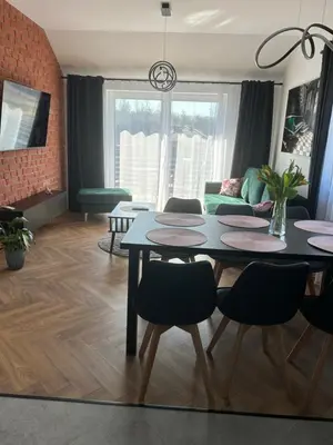 a living room with a table and chairs at DS Apartamenty Zator in Zator
