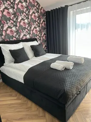 a bedroom with a bed with two towels on it at DS Apartamenty Zator in Zator
