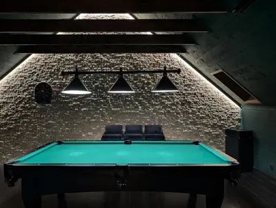 a pool table in a room with two chairs at Płachtówka in Słupia