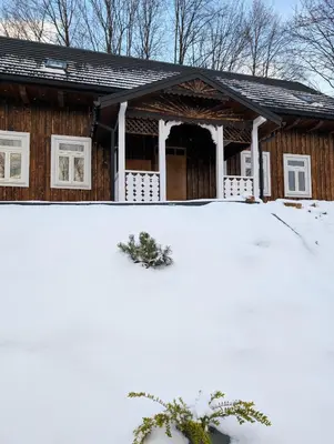 a house with snow in front of it at Płachtówka in Słupia