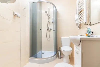 a bathroom with a shower and a toilet and a sink at Apartments Iris-Topolowa in Kraków