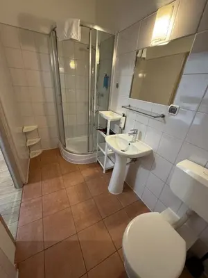 a bathroom with a toilet and a sink and a shower at Apartments Iris-Topolowa in Kraków