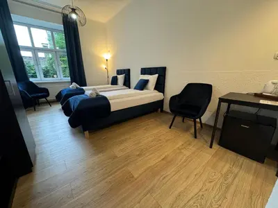 a bedroom with a bed and a desk and a desk at Apartments Iris-Topolowa in Kraków