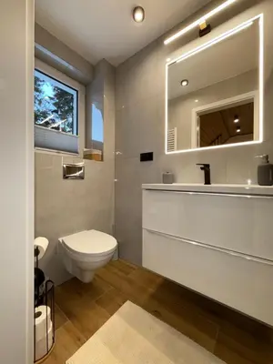 a bathroom with a toilet and a sink and a mirror at Agroturystyka Pod Jałowcem in Stryszawa