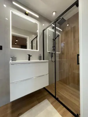 a bathroom with a white sink and a shower at Agroturystyka Pod Jałowcem in Stryszawa