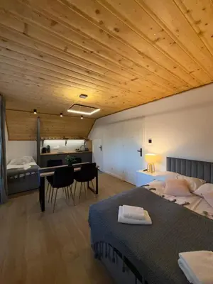 a bedroom with two beds and a desk and a table at Agroturystyka Pod Jałowcem in Stryszawa