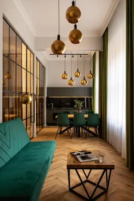 a living room with a green couch and a table at OLD TOWN Charm & Chic by Downtown Apartments in Kraków