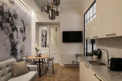 a kitchen and living room with a table and a couch at OLD TOWN Charm & Chic by Downtown Apartments in Kraków